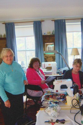 Kathy, Robin, and Ruth quilting in the Tavern Room